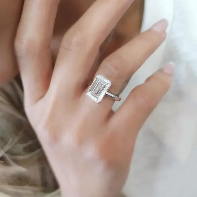 Hand wearing Eternity Prism emerald-cut diamond ring in silver setting