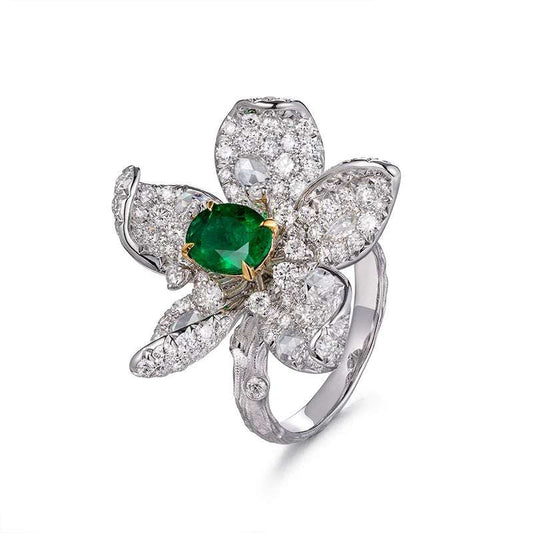 Luxury recycled 18ct gold flower-shaped ring with natural emerald and diamond accents