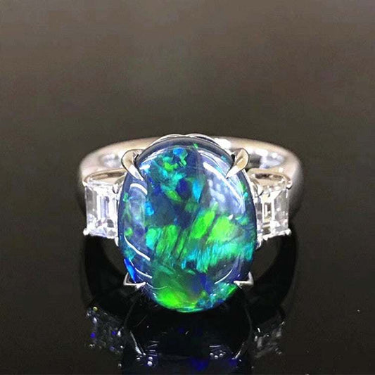 SGARIT Rare Precious Gems platinum ring with 5.63ct vibrant black opal and side diamonds for women.