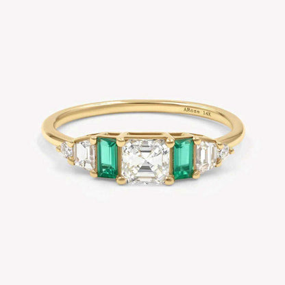 Hall of Emerald Ring featuring 14k yellow gold band with Asscher-cut diamond center and rectangular emerald accents