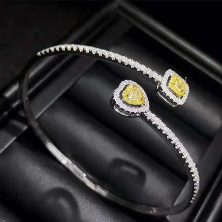 18k gold bangle bracelet with natural yellow diamond charm and small white diamonds