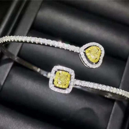 18k gold bangle bracelet with natural yellow diamond charm and sparkling white diamonds