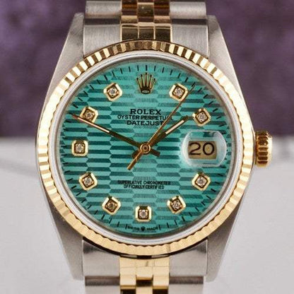 Date-just of the Azure Aegis Rolex watch with blue patterned dial, diamond hour markers, gold fluted bezel, and two-tone Jubilee bracelet.