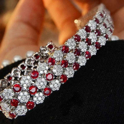 18K white gold tennis bracelet with natural rubies and diamonds in an intricate design