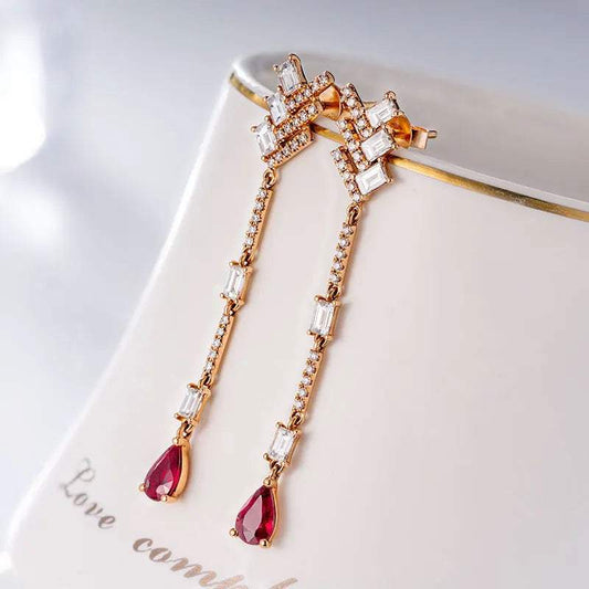 18K white gold diamond dangle earrings with pear-shaped red gemstones and rectangular diamonds