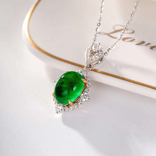 Luxury bridal jewelry featuring a genuine 18k white gold pendant with a natural emerald and diamond accents