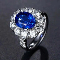 White gold ring with a natural blue sapphire center stone surrounded by sparkling diamonds, called the Star of Ithil.