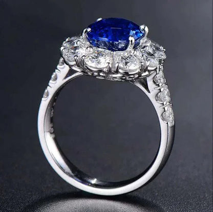 White gold ring featuring a natural blue sapphire center stone named Star of Ithil, surrounded by smaller diamonds.