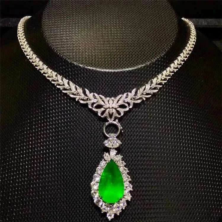 Heart of the Enchanted Forest™ necklace featuring a 12.78ct vivid green emerald pendant set in 18K gold surrounded by diamonds.