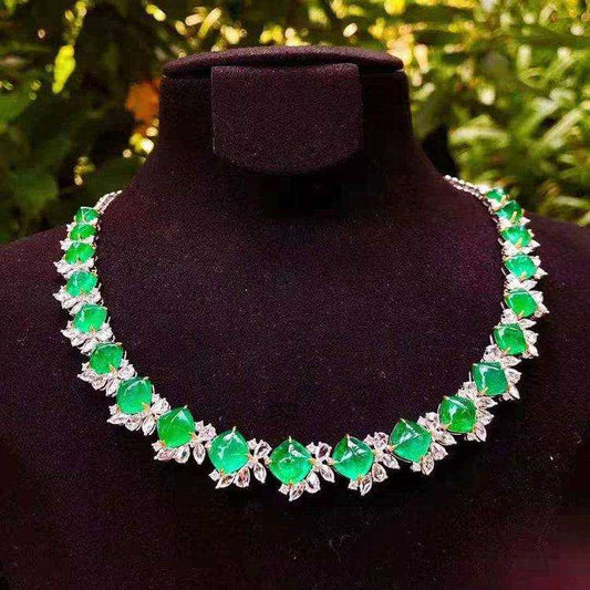 Diadem of the Verdant Dawn 18K white gold necklace with 44.32 ct vivid green emeralds and diamond accents on black display bust
