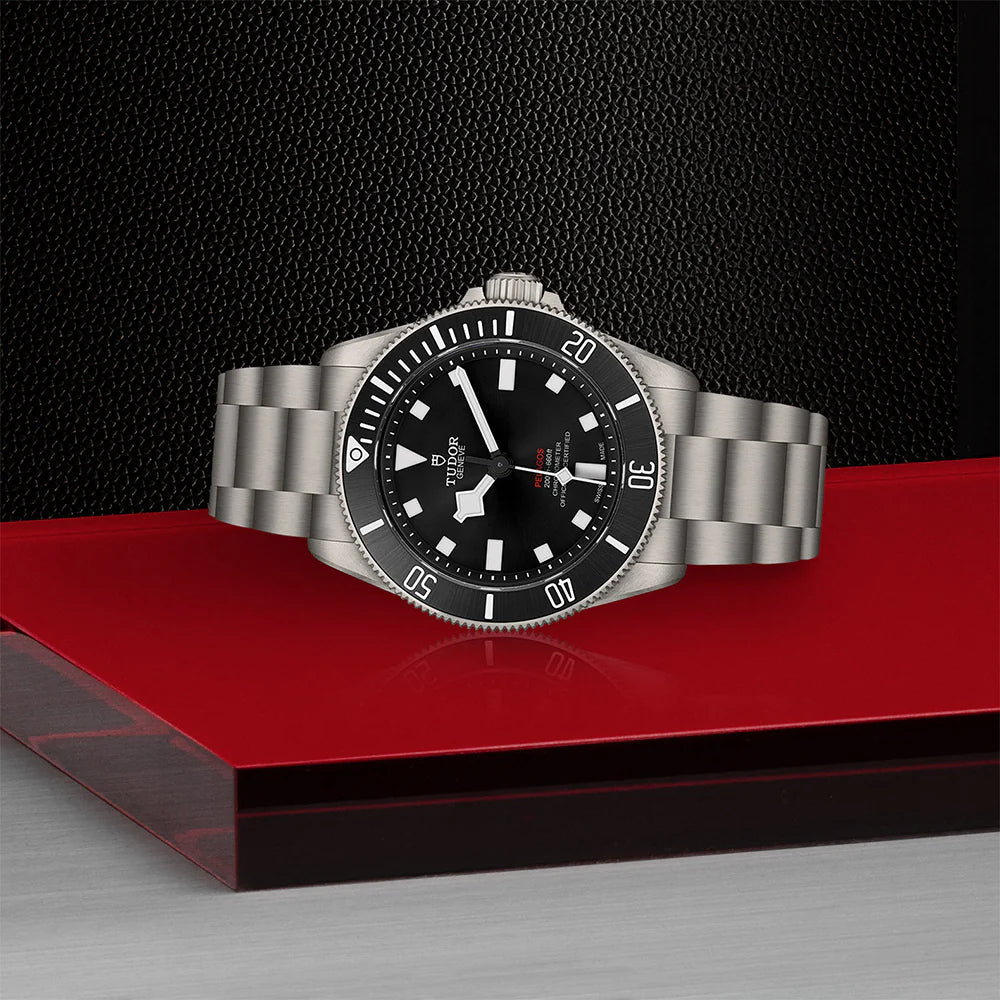 Tudor Pelagos 39 Black Dial watch with titanium case and bracelet on red and black surface