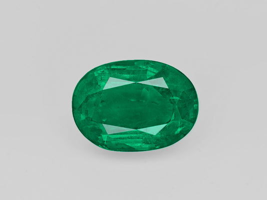 Deep green oval-shaped 5.47 carat natural Zambian emerald gemstone certified by GII