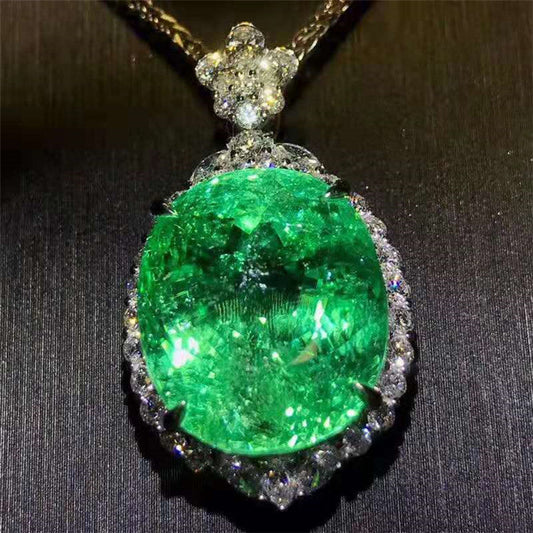 Verdant Veil of Arcanum pendant featuring a 28.35ct neon green Paraiba Tourmaline surrounded by sparkling diamonds in 18K gold setting